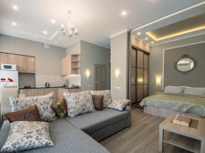 Apartment with a Balcony Next to a Summer Garden